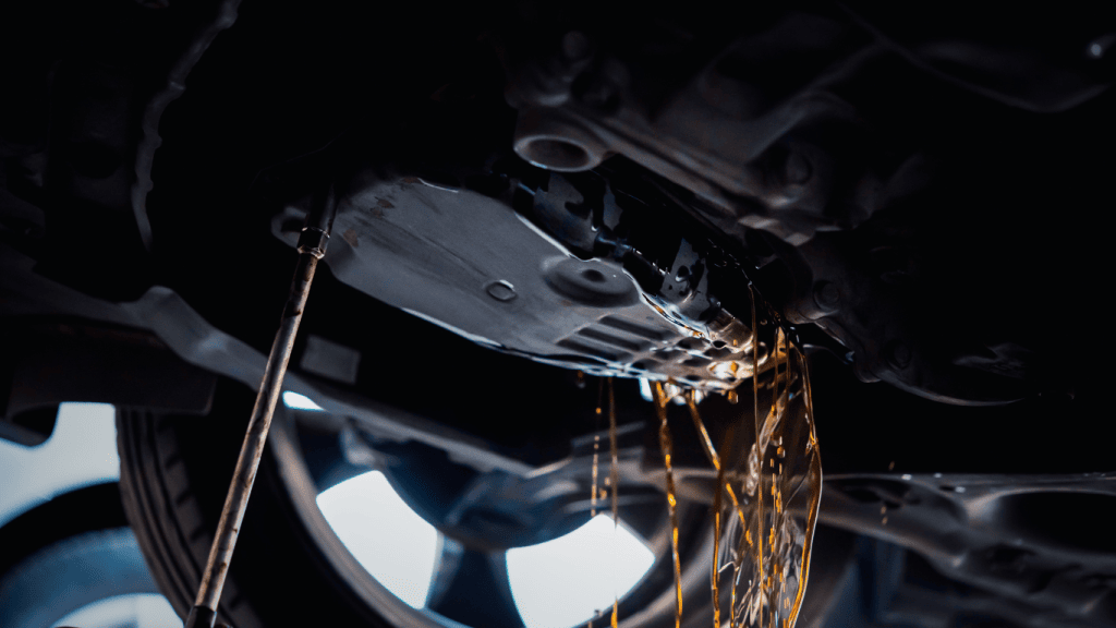 Transmission Fluid Change: How to Do It Yourself 1 Old transmission fluid draining from the transmission pan