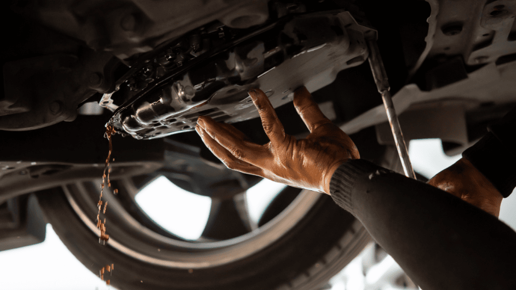 6 Warning Signs of Low Transmission Fluid You Shouldn’t Ignore 1 Transmission fluid dripping from the transmission pan under a car
